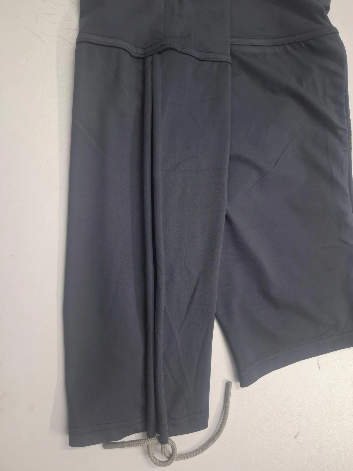 Charcoal activewear shorts side detail for custom biker shorts and cycling shorts manufacturing in Bangladesh.