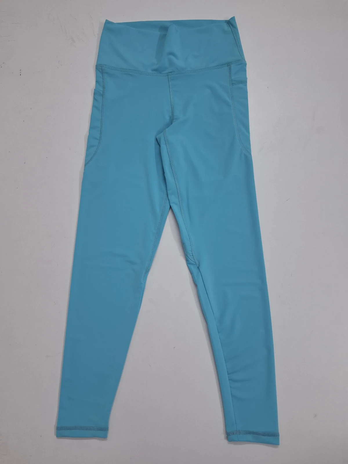 Blue leggings full product view for custom activewear bottoms manufacturing in Bangladesh by Brandex Sourcing.
